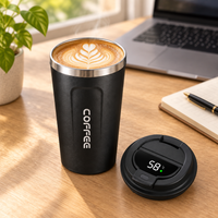 Smart coffee cup with the lid off showing latte art, smart lid displaying the temperature